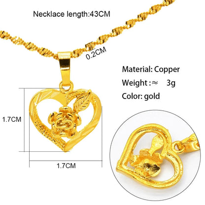 Gold necklace with heart-shaped and flower pendant on a white background