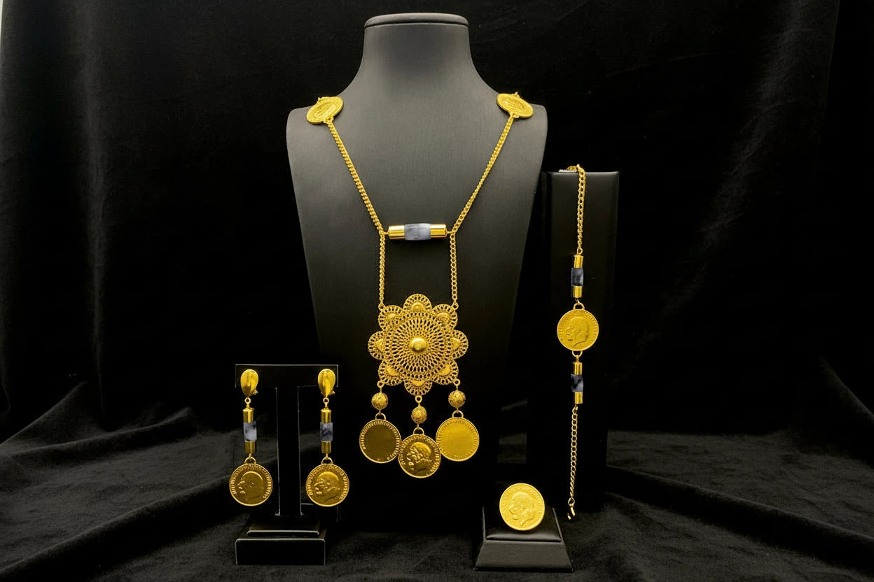 Gold necklace and earrings set on a black mannequin against a black background